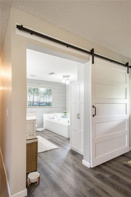 313 White Pine Highway, Nicholls, GA 31554 - full bath with wood finished floors, a bath, vanity, and a textured ceiling