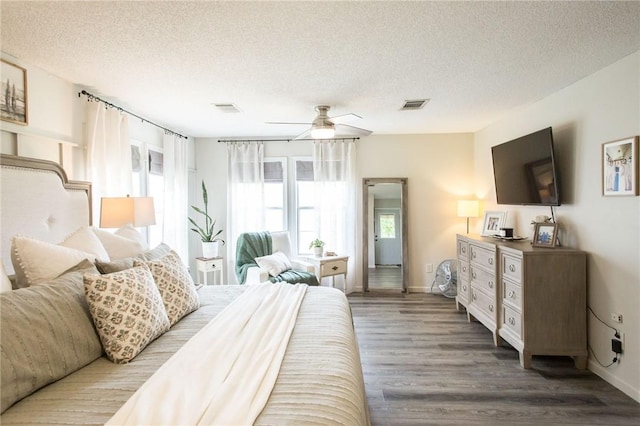 313 White Pine Highway, Nicholls, GA 31554 - bedroom featuring a textured ceiling, wood finished floors, baseboards, and ceiling fan