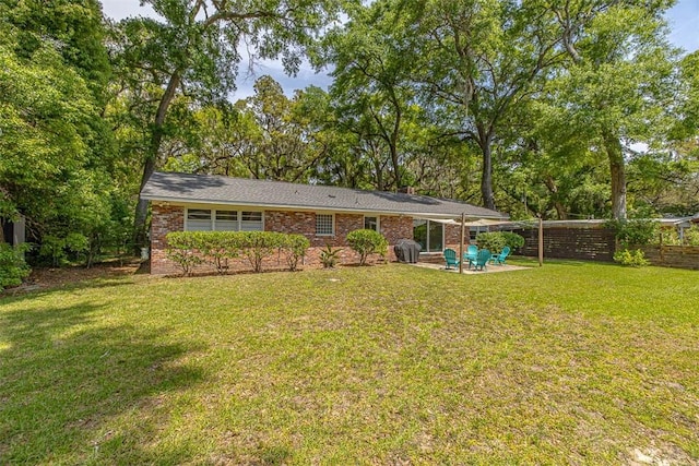 back of house featuring a patio area and a yard