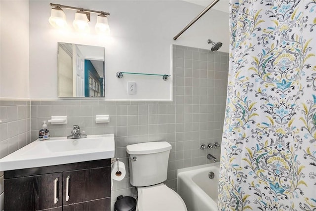 full bathroom with vanity, toilet, tile walls, and shower / tub combo with curtain