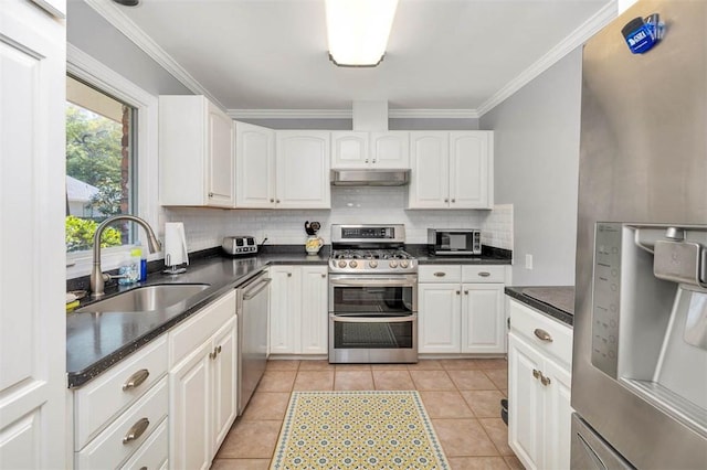 kitchen featuring sink, light tile patterned flooring, crown molding, white cabinets, and appliances with stainless steel finishes