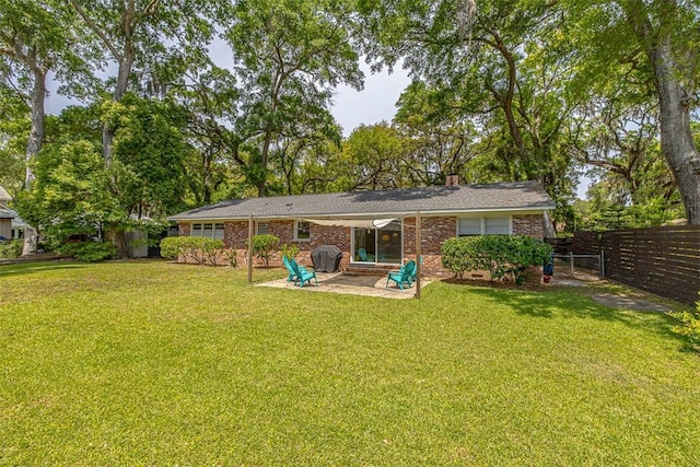 back of house featuring a yard and a patio area