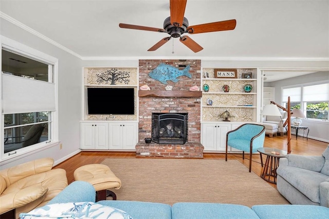 living room with light wood-type flooring, ceiling fan, and ornamental molding