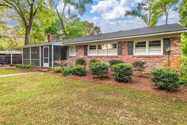 ranch-style home with a sunroom and a front lawn