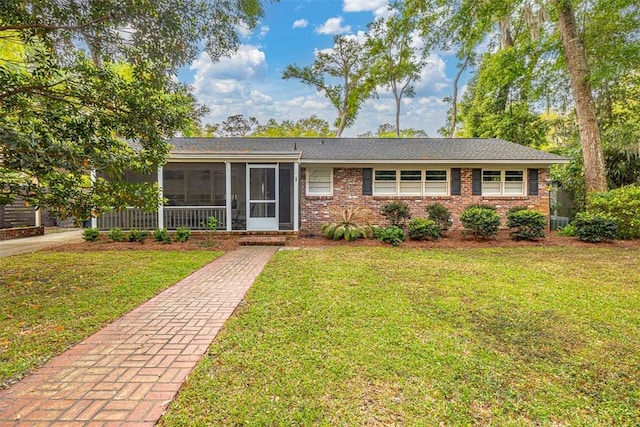 single story home with a sunroom and a front lawn