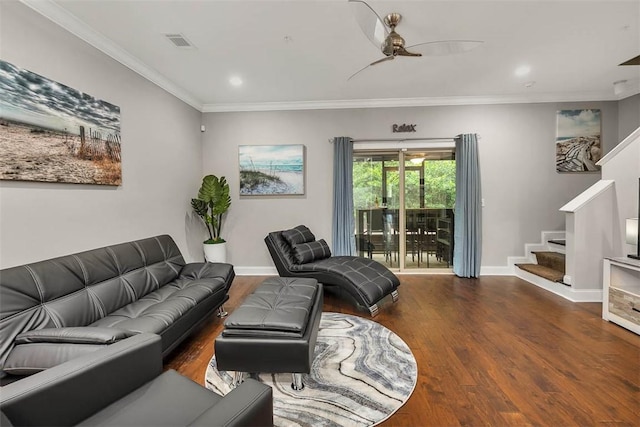 living area featuring baseboards, visible vents, ornamental molding, wood finished floors, and stairs