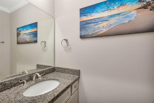 bathroom featuring crown molding and vanity