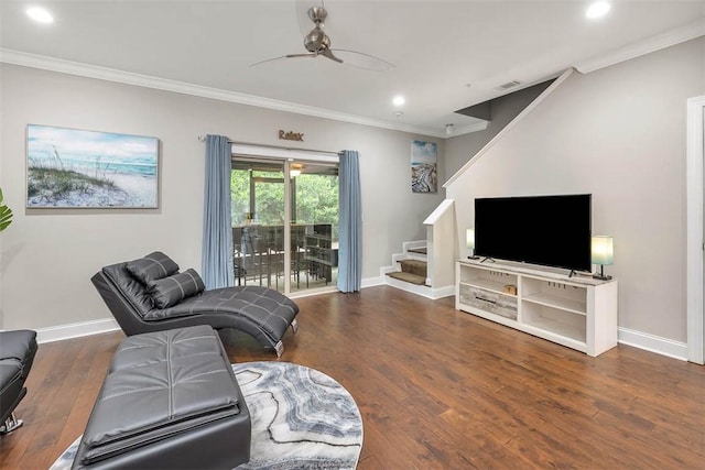 living room with dark wood-type flooring, ceiling fan, and crown molding