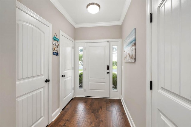 entrance foyer featuring ornamental molding, dark wood finished floors, and baseboards