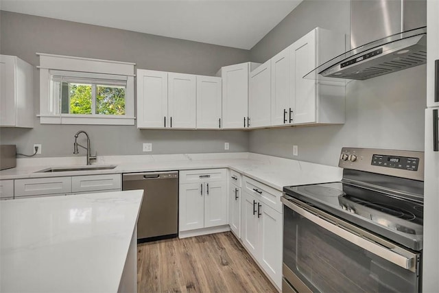 12 Hunters Dr, Brunswick, GA 31523 - kitchen featuring stainless steel appliances, wall chimney exhaust hood, and white cabinetry