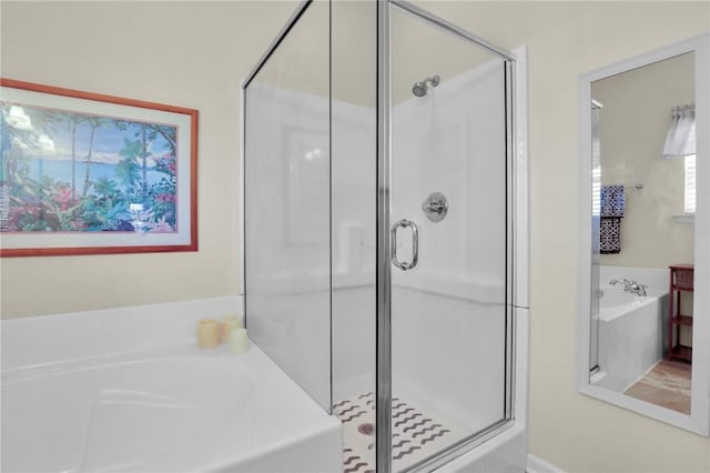 bathroom featuring separate shower and tub