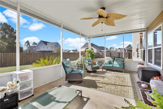 sunroom featuring ceiling fan