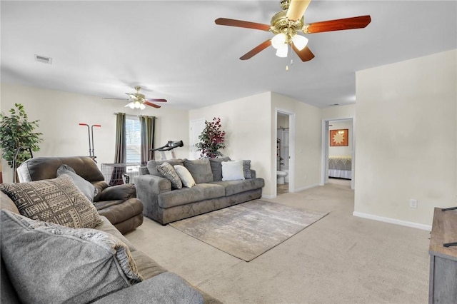 carpeted living room with ceiling fan