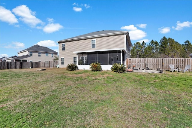 rear view of house with a lawn and a sunroom