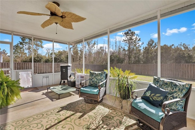 sunroom / solarium featuring ceiling fan