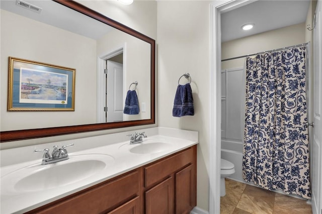 full bathroom featuring tile patterned floors, toilet, vanity, and shower / tub combo