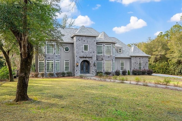 french provincial home featuring a front yard