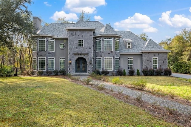 french provincial home with a front yard