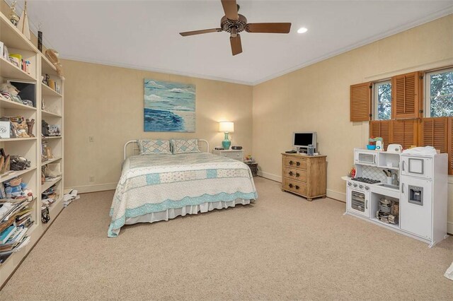 carpeted bedroom featuring ceiling fan and crown molding