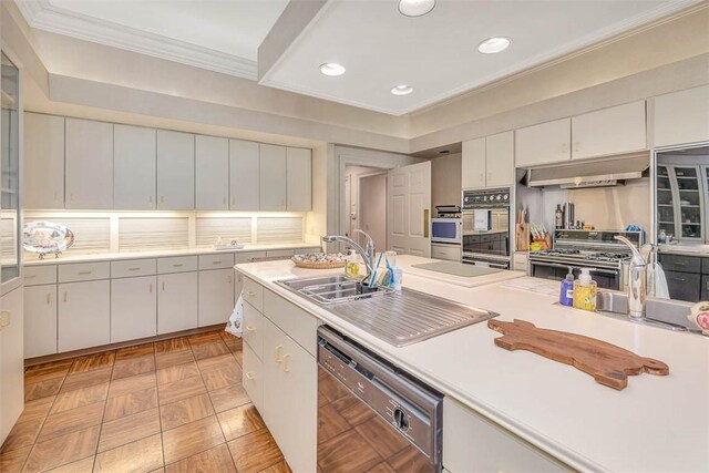 kitchen with black appliances, crown molding, white cabinets, and sink