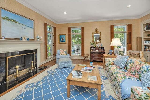 living room featuring hardwood / wood-style floors, a wealth of natural light, and ornamental molding