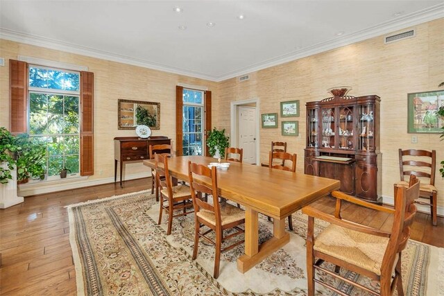 dining area featuring crown molding and wood-type flooring