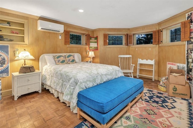 bedroom with wood walls, an AC wall unit, and parquet floors