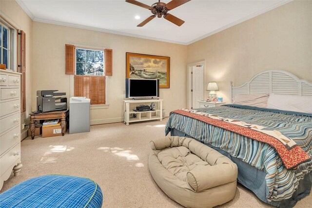 carpeted bedroom with ceiling fan and ornamental molding