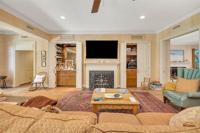 living room with ceiling fan and ornamental molding