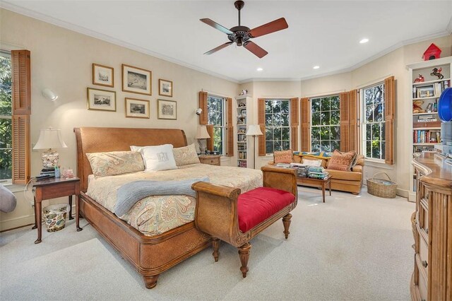 bedroom with ceiling fan, light colored carpet, and ornamental molding