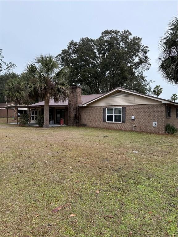 back of house with a yard