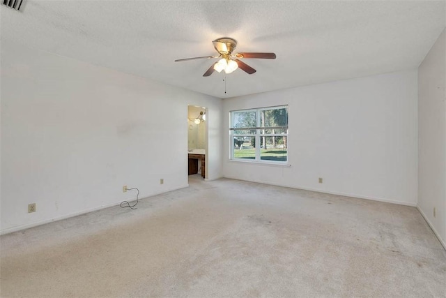 carpeted empty room with a textured ceiling and ceiling fan