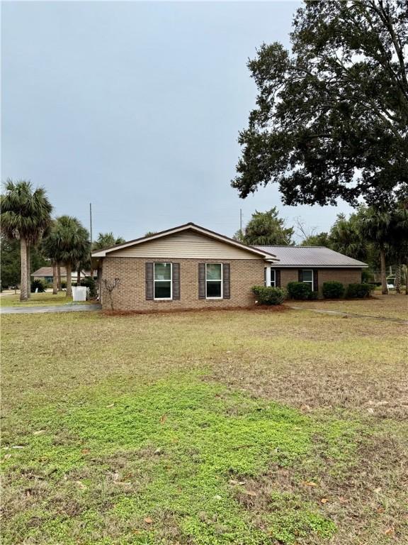 view of side of property with a yard