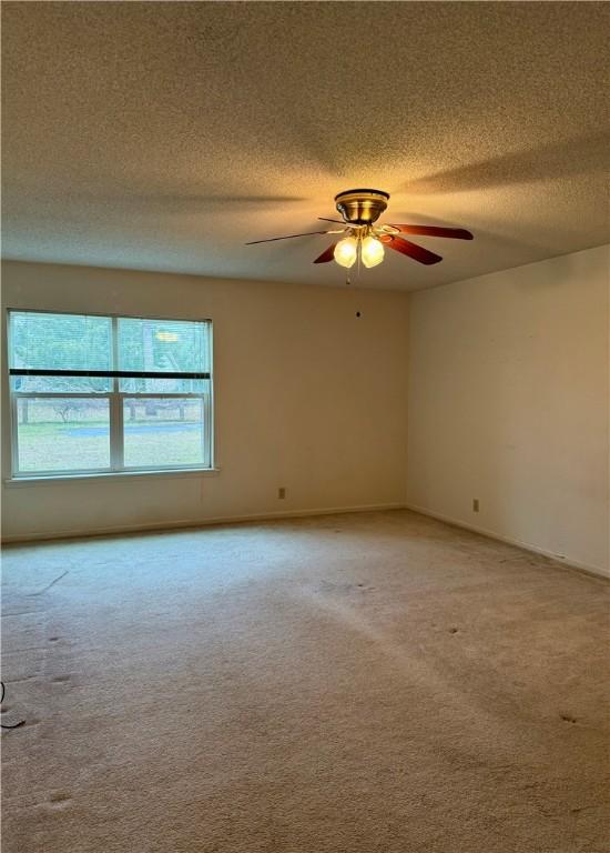 carpeted empty room with ceiling fan