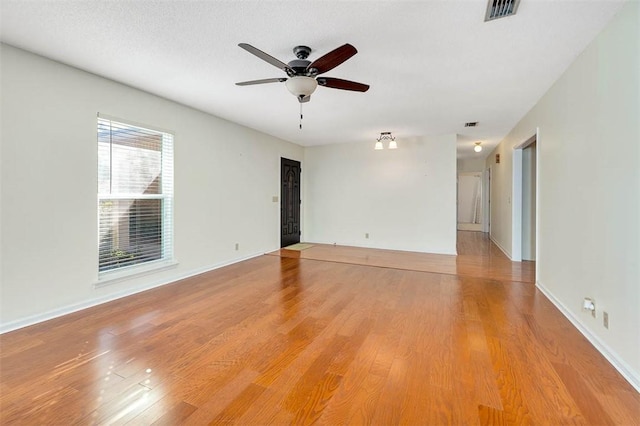 unfurnished room featuring ceiling fan, a textured ceiling, and light hardwood / wood-style floors