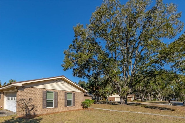 view of side of property featuring a garage and a yard