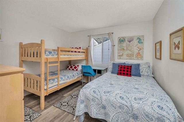 bedroom featuring hardwood / wood-style flooring and a textured ceiling