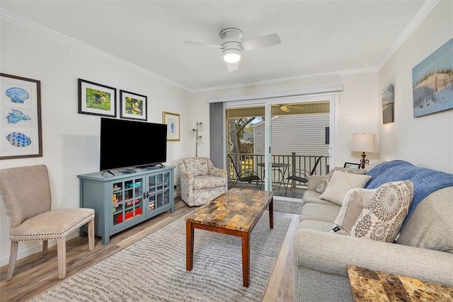 living room featuring crown molding, ceiling fan, and wood-type flooring