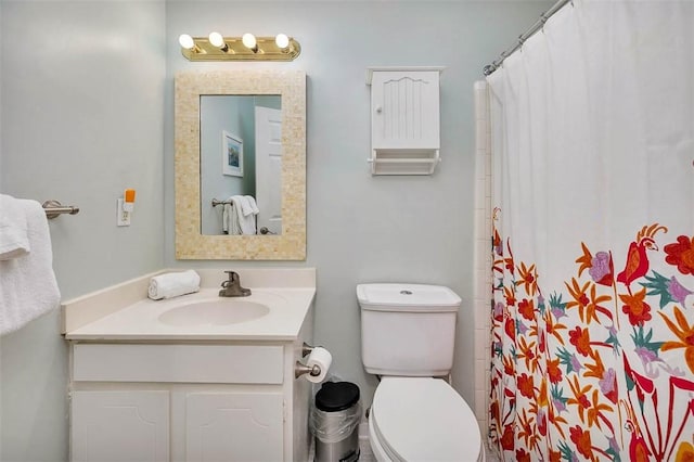 bathroom with vanity, walk in shower, and toilet