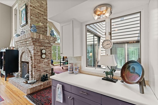 207 Military Rd, Saint Simons Island, GA 31522 - bar area featuring light wood-type flooring and a brick fireplace