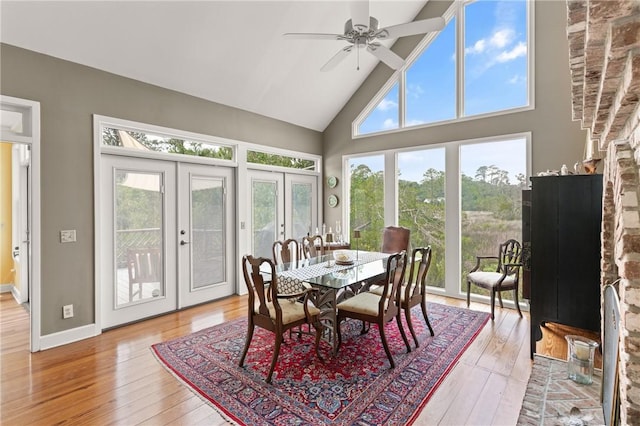 207 Military Rd, Saint Simons Island, GA 31522 - dining space featuring high vaulted ceiling, french doors, light wood-style flooring, and plenty of natural light