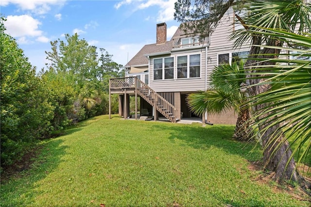 207 Military Rd, Saint Simons Island, GA 31522 - back of property featuring a chimney, stairway, a deck, and a lawn