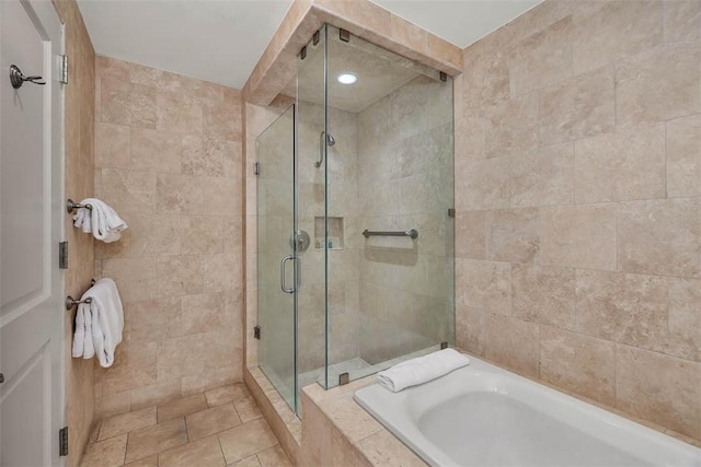 bathroom featuring tile patterned floors and plus walk in shower