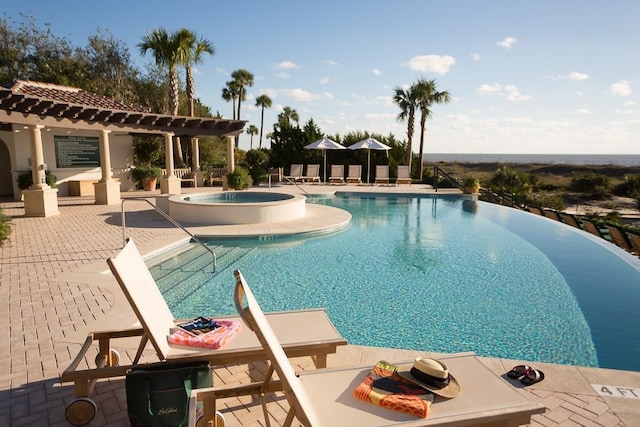 view of pool with a community hot tub and a patio area