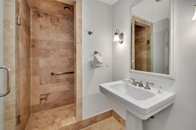 bathroom with walk in shower and sink