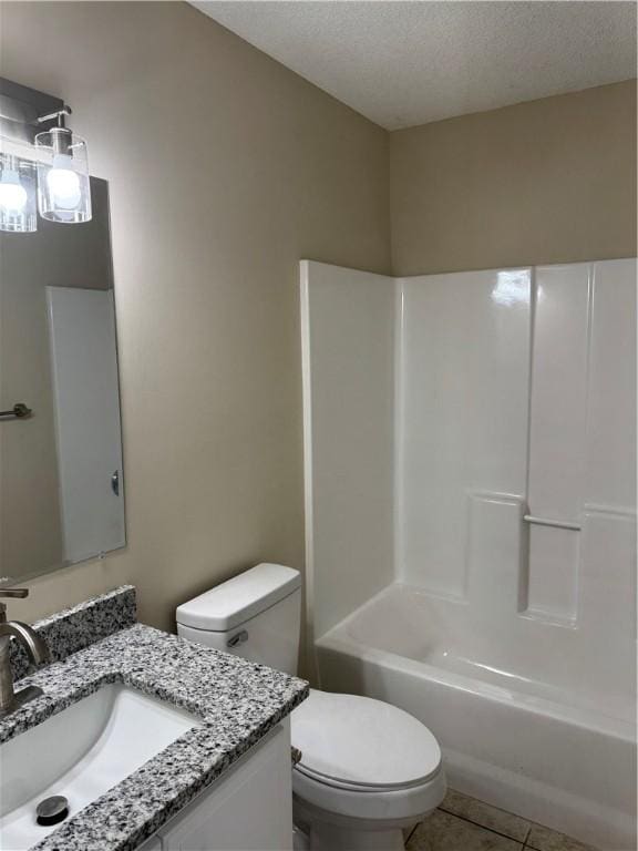 full bathroom featuring tub / shower combination, tile patterned floors, a textured ceiling, toilet, and vanity