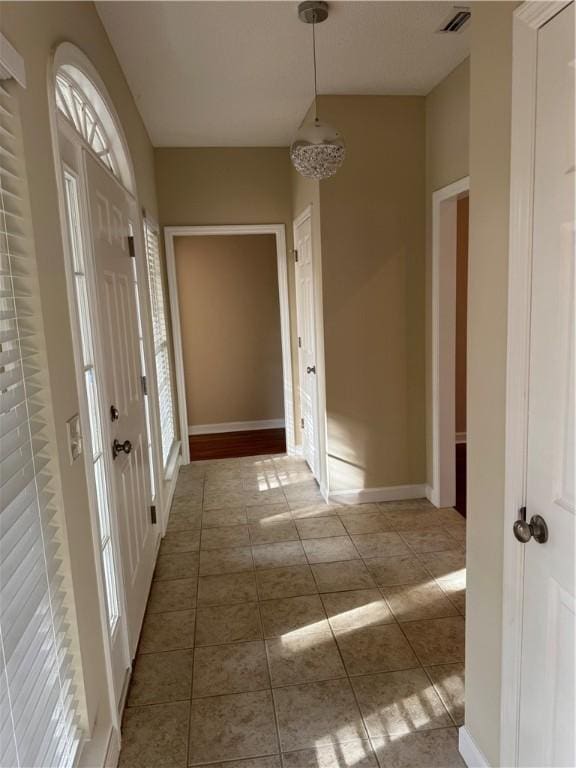 hallway with tile patterned floors