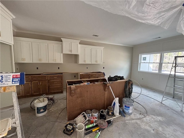 kitchen with visible vents and white cabinets