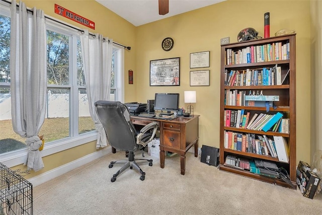 carpeted home office with ceiling fan