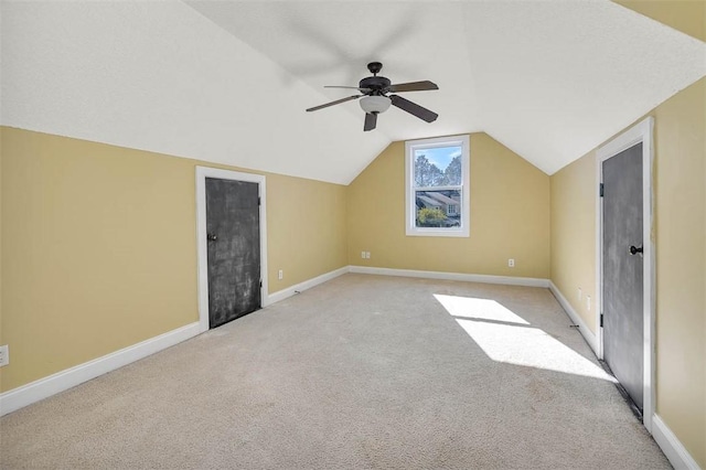 bonus room with light carpet, vaulted ceiling, and ceiling fan